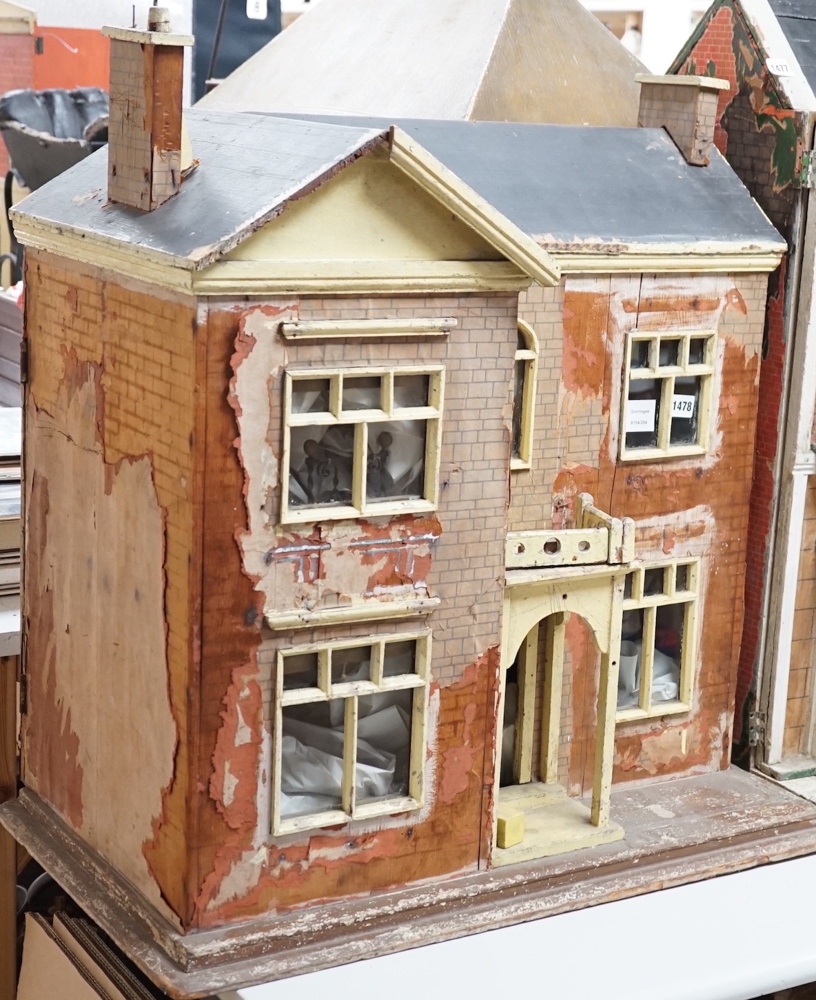 An English back-opening furnished dolls’ house, c.1900, modelled as a double-fronted brick villa, 75cms wide x 80cms high